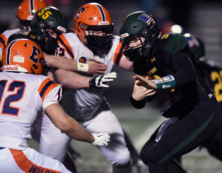 Glenbrook North quarterback Avery Burow carries the ball as the Evanston defense closes in during Friday's game in Northbrook.