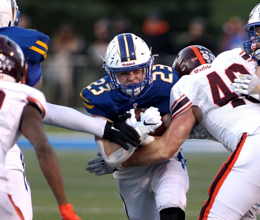 Wheaton North's Brayton Maske (23) carries the ball during a Class 7A semifinal against Brother Rice at Wheaton North on Saturday, Nov. 20, 2021.