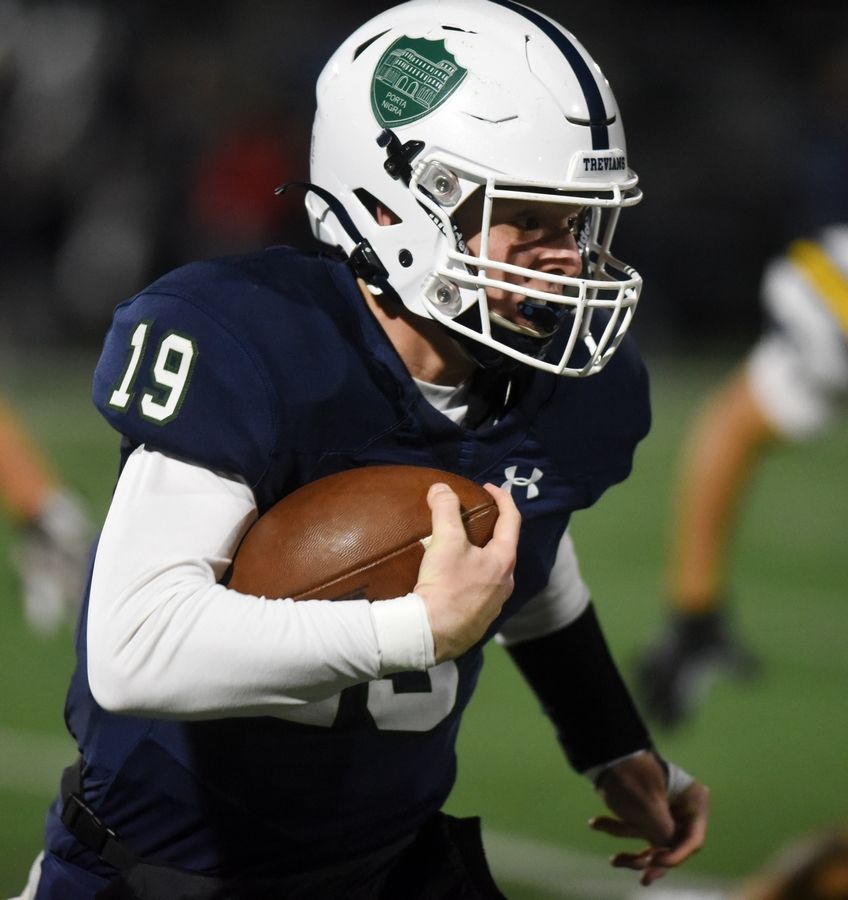 New Trier Patrick Heneghan carries the ball during Friday's game against Glenbrook South.