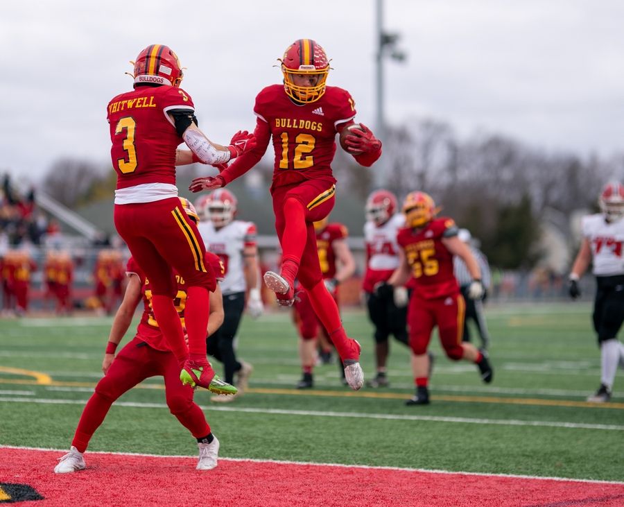 Batavia's Luke Alwin (12) celebrates with Ryan Whitwell (3) after scoring a touchdown against Yorkville during last week's Class 7A quarterfinal win.